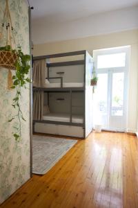 a room with a bunk bed with a wooden floor at Baloo Hostel in Athens