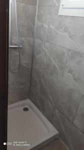 a bathroom with a shower with a white tub at Le petit chalet in Gapennes +8 photos