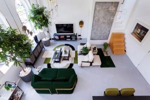 an overhead view of a living room with green furniture at Veeve - Brazilian Trailblazer in London
