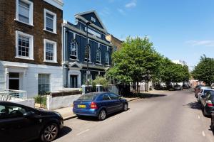 a blue car parked in front of a blue building at Veeve - Brazilian Trailblazer in London