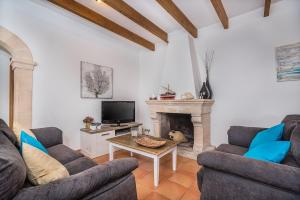 a living room with two couches and a fireplace at Can Mateu in Pollença