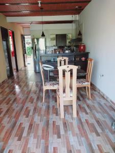 a kitchen with a table and chairs on a wooden floor at CASA PROYECTO GIGANTE in Gigante