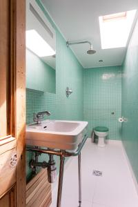 a bathroom with a sink and a toilet at Veeve - Parkland Perfection in London