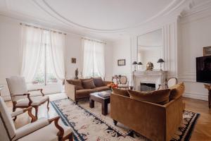 uma sala de estar com um sofá e uma lareira em Veeve - Palatial Grandeur em Paris