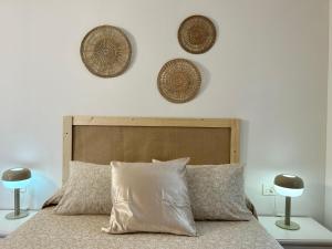 1 dormitorio con 1 cama con 3 cestas en la pared en CASA LALA by Liamar en Playa Honda