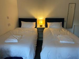 two beds sitting next to each other in a room at Abbie Lodge Guest House in Weston-super-Mare