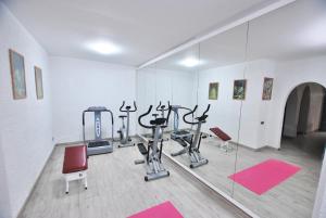 a gym with several exercise bikes and a mirror at Sunny house in Cabrils