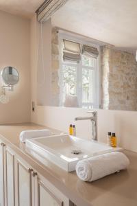 een witte badkamer met een wastafel en een spiegel bij Veeve - Artistic Flamboyance in Boulogne-Billancourt