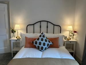 a bedroom with a bed with pillows on it at The Victoria Hotel,Bar,Bistro in Norham