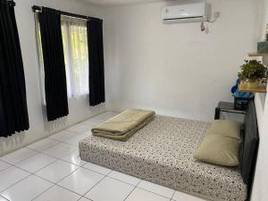 a room with a bed in the middle of a room at Coral House - Near Univ Indonesia Setu Babakan in Jakarta