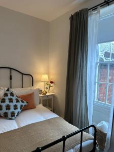 a bedroom with a bed next to a window at The Victoria Hotel,Bar,Bistro in Norham