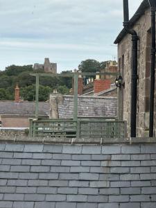 a building with a bench on top of a roof at The Victoria Hotel,Bar,Bistro in Norham
