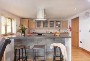 a kitchen with a large island with bar stools at Main Beach in Redruth