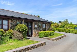 a stone house with a pathway in front of it at Main Beach in Redruth