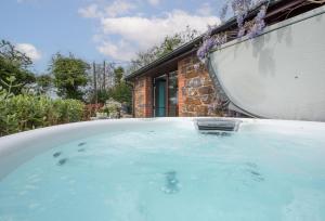 a hot tub in the backyard of a house at Main Beach in Redruth