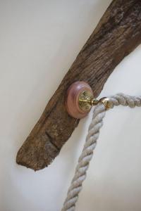 a wooden object with a rope attached to a wall at The Honeypot in Chipping Campden