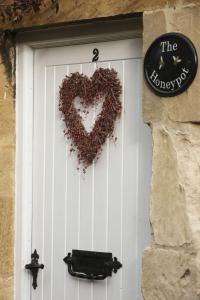 a white door with a heart on it at The Honeypot in Chipping Campden