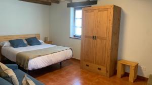 a bedroom with a bed and a wooden cabinet at IRATIKO KABIAK in Orbaiceta +64 photos