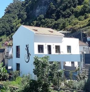 a house with a motorcycle on the side of it at Lazy Lizard by the Ocean in Seixal