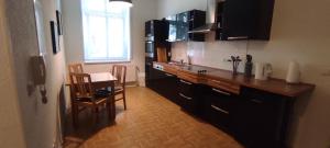 a kitchen with a counter and a table and chairs at Apartment Cottbus City - Erdgeschoss in Cottbus