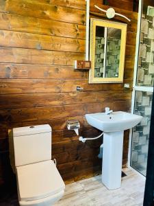 a bathroom with a toilet and a sink at Kaaya Eco Resort Yala in Tissamaharama