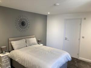 a bedroom with a bed and a mirror on the wall at Kimberley Holiday Apartments in Cleveleys