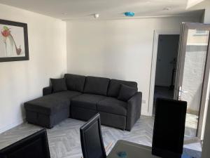 a living room with a couch and a table at Kimberley Holiday Apartments in Cleveleys