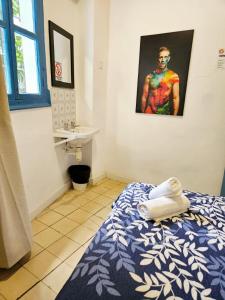 a bathroom with a bed and a sink in a room at Arc House Mezquita - Only adults in Córdoba