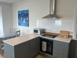 a kitchen with a counter top and a stove top oven at High Tides in Lyme Regis