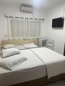Rúm í herbergi á Versatile Park Hotel