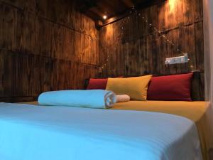 a bedroom with a large bed with wooden walls at La pinchi " Pinchi's Bed " in Gampola
