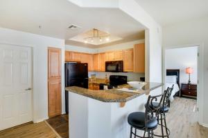 a kitchen with a counter and stools in a room at Tranquil Scottsdale Condo with Community Pool! in Scottsdale