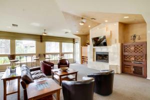 a living room with a couch and a fireplace at Tranquil Scottsdale Condo with Community Pool! in Scottsdale