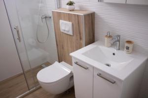 a bathroom with a toilet and a sink and a shower at Apartment Nikola Škarica 1 in Duće +27 photos