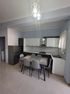 a kitchen with a table and chairs and a dining room at Family Oasis in Vlorë