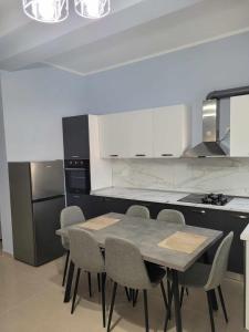 a kitchen with a table and chairs in it at Family Oasis in Vlorë