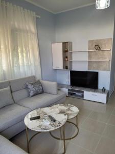 a living room with a couch and a coffee table at Family Oasis in Vlorë