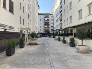an empty courtyard with potted trees and buildings at Casa Daniela in Naples