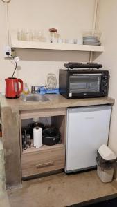 a kitchen counter with a microwave and a refrigerator at Interra Apart 2 in Salta