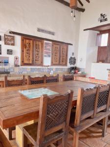 a dining room with a large wooden table and chairs at Casa Real Barichara in Barichara
