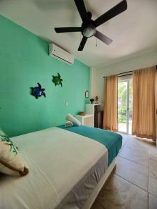 a bedroom with a bed with a ceiling fan at blue BOCANA in Santa Cruz Huatulco