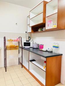 a kitchen with a counter with a counter top at Sofea Homestay Ipoh in Ipoh
