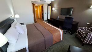 una camera d'albergo con letto e scrivania di Hotel Diego de Almagro Alto el Loa Calama a Calama