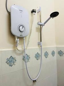 a shower in a bathroom with a shower head at Sofea Homestay Ipoh in Ipoh
