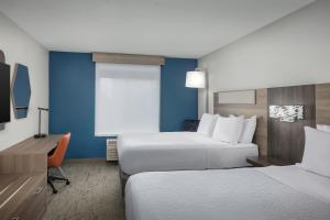 a hotel room with two beds and a desk at Holiday Inn Express & Suites Superior, an IHG Hotel in Superior
