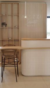 a kitchen with a table and a chair at Aqua Vista Infinity Spa & Pool Studio Lux in Mamaia Sat/Năvodari