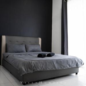 a bed with two hats on it in a bedroom at Hayyan cozy place in Kuala Kedah +9 photos