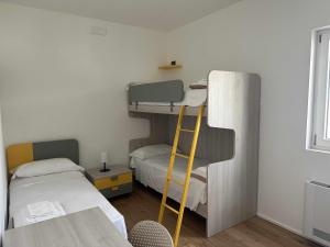 a room with two bunk beds and a ladder at Casa del Sol Luxury Estate Puglia in Leporano Marina