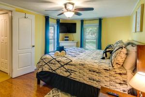 a bedroom with a bed and a ceiling fan at Waycross Vacation Rental with Private Backyard! in Waycross +16 photos