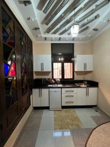 a large kitchen with white cabinets and a ceiling at "Pearl in Middle Atlas" in Azrou